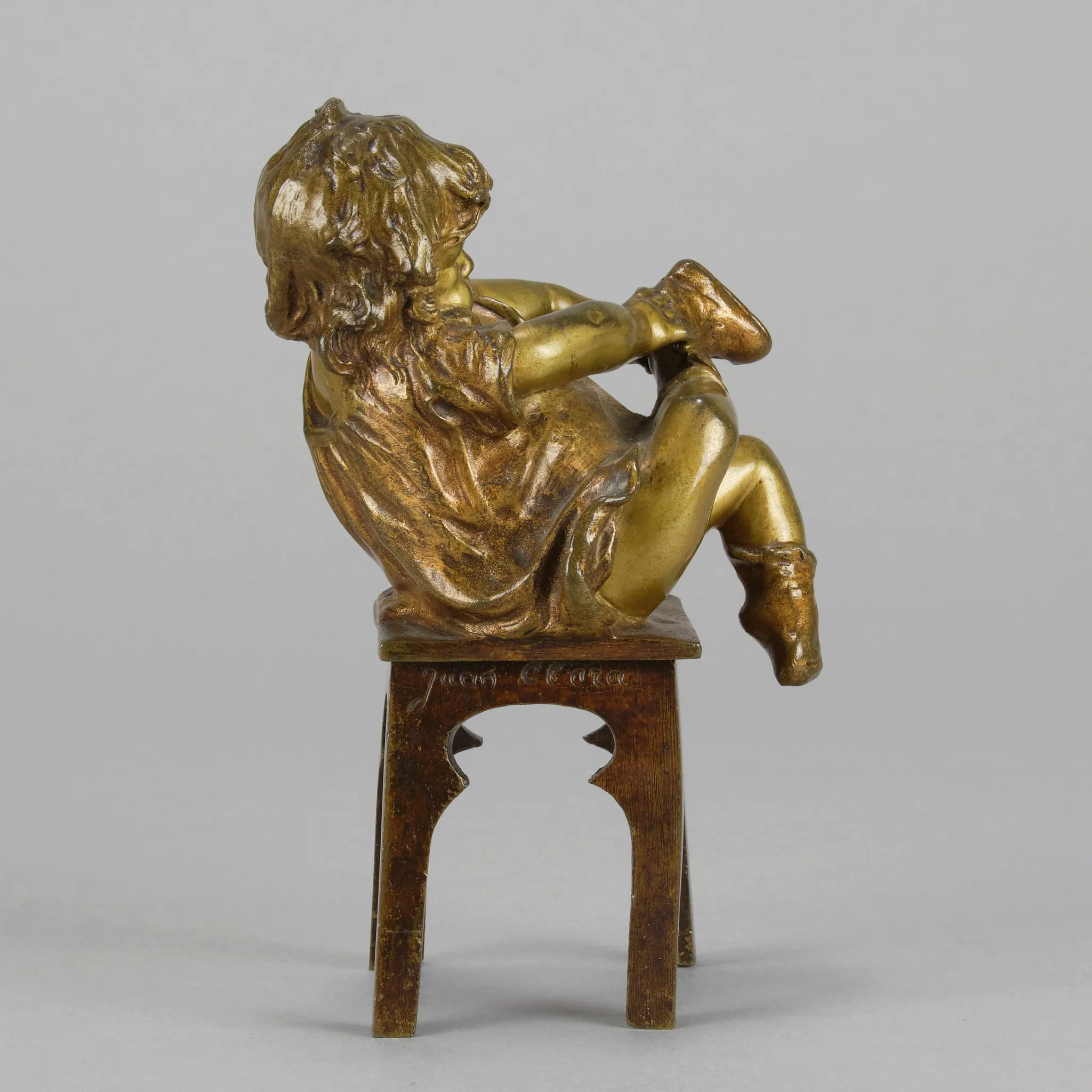 "Girl Putting on her Shoe" by Juan Clara