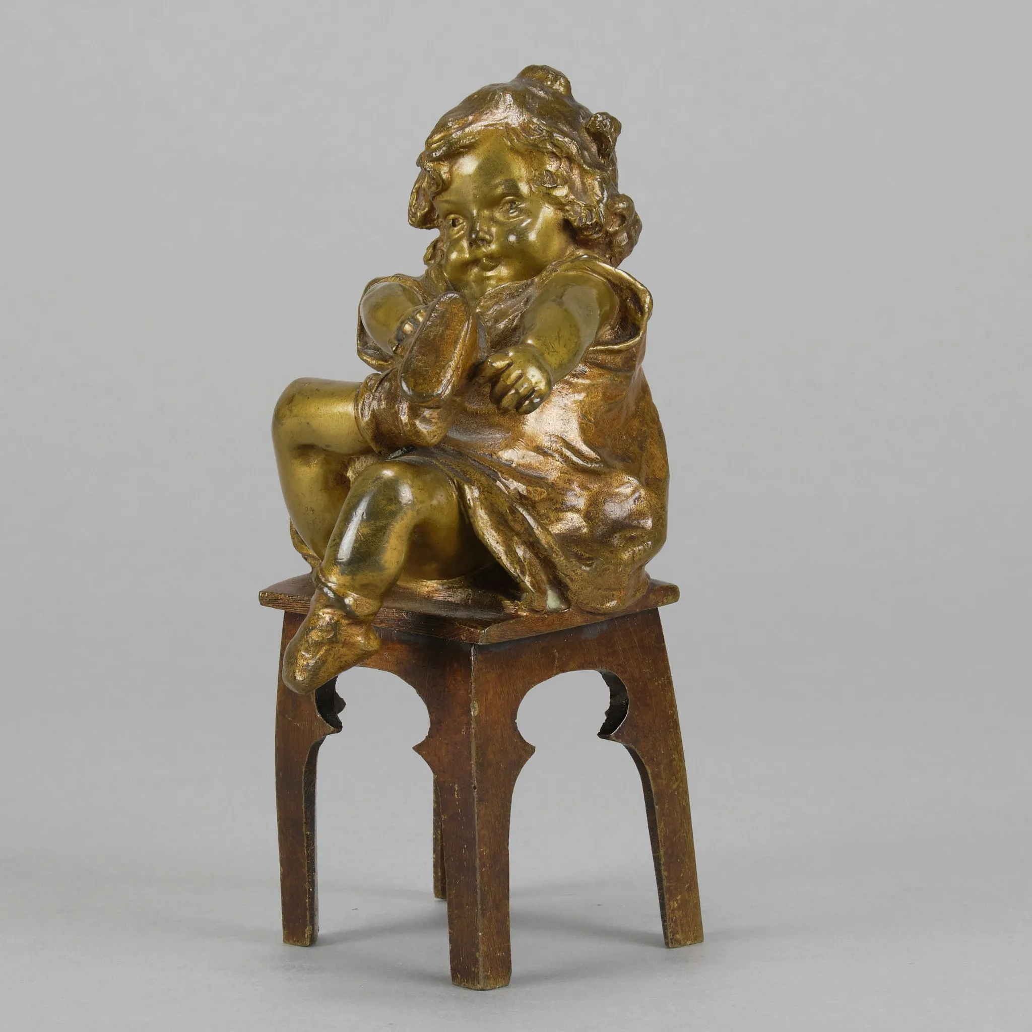 "Girl Putting on her Shoe" by Juan Clara