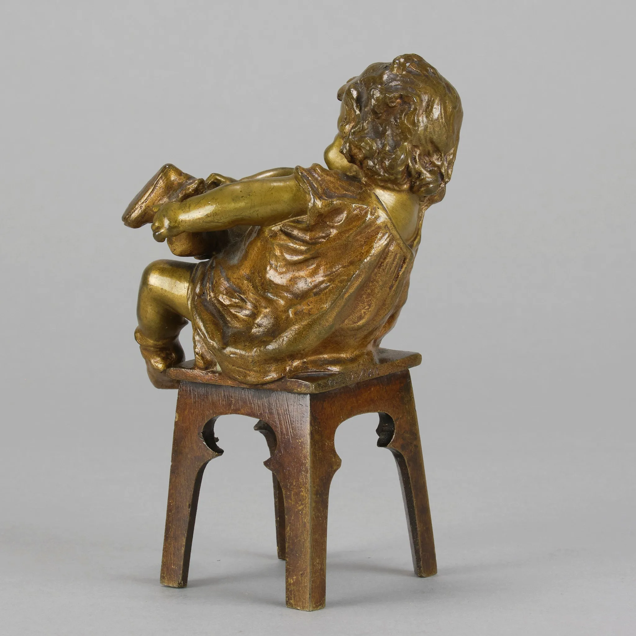 "Girl Putting on her Shoe" by Juan Clara